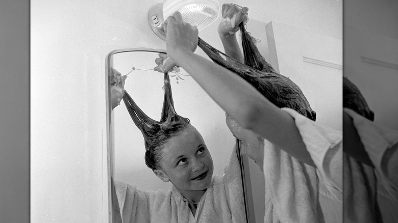 A young girl styling her hair