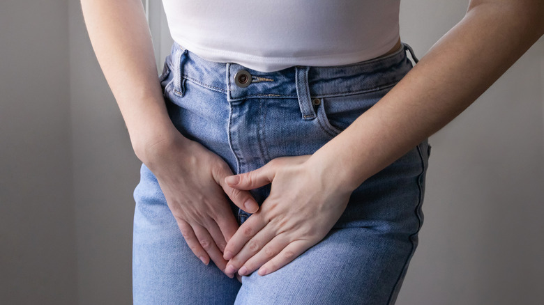 Woman hands holding crotch suffering from yeast infection symptoms