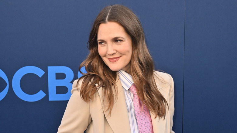 Drew Barrymore smiling and posing at a public event after embracing sobriety