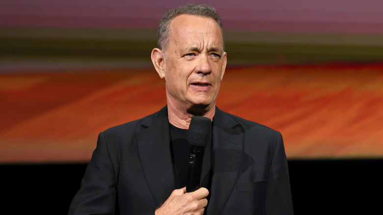 Tom Hanks speaking to a crowd at an event