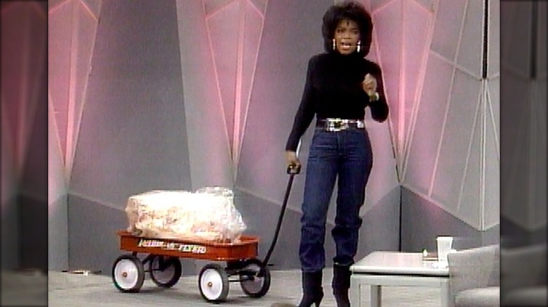 Oprah Winfrey holding a wagon of animal fat