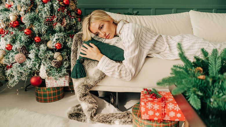 woman sits looking sad and lonely 