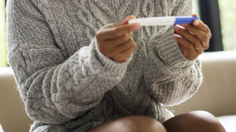 Hands holding pregnancy test