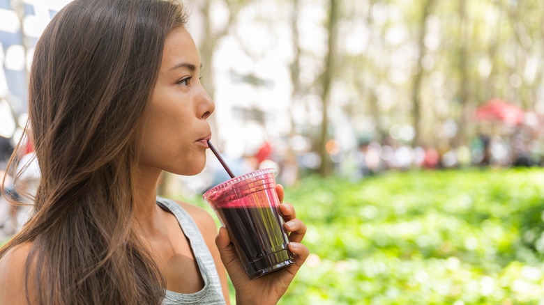 woman drinking smoothie