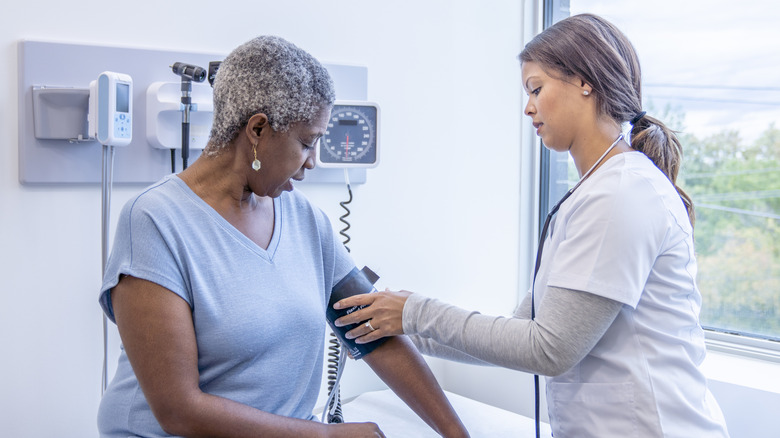 woman getting her blood pressure checked