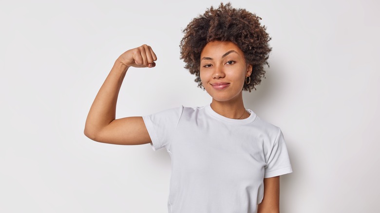 confident woman flexing her bicep