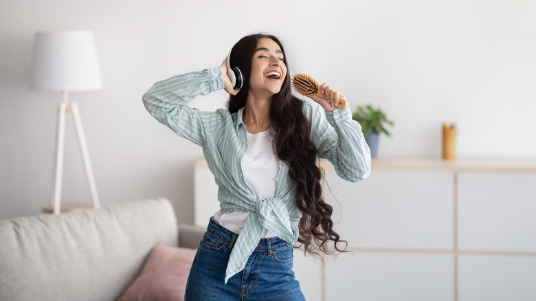 young woman dancing in living room 
