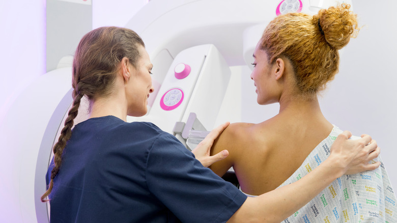 Doctor assisting patient with mammogram