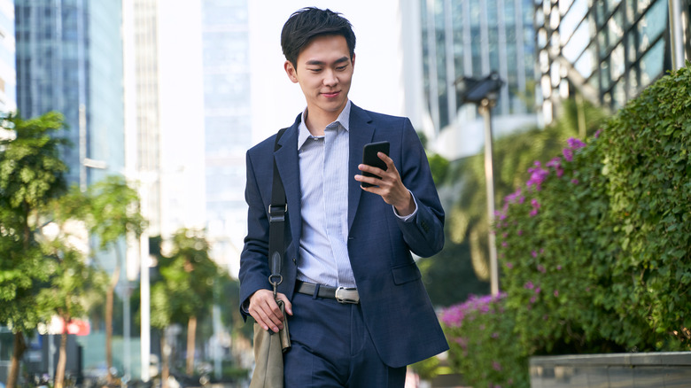 Man walking down street with phone