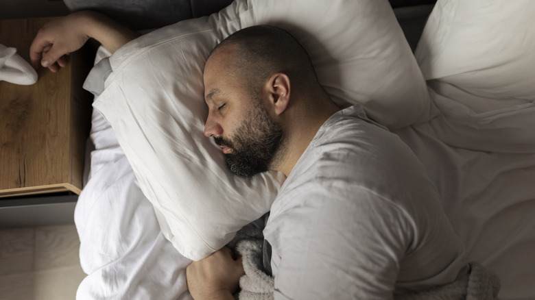 man sleeping in bed