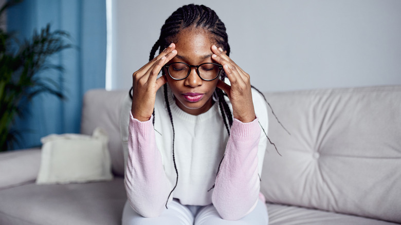 woman having anxiety while sitting down at home
