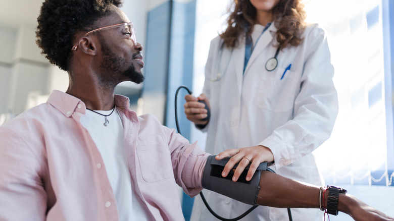 young man getting blood pressure checked