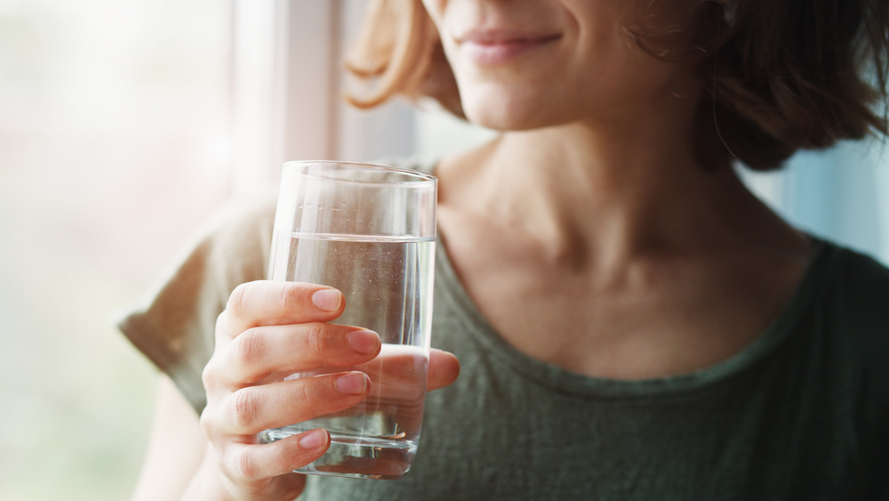 woman holding water glass