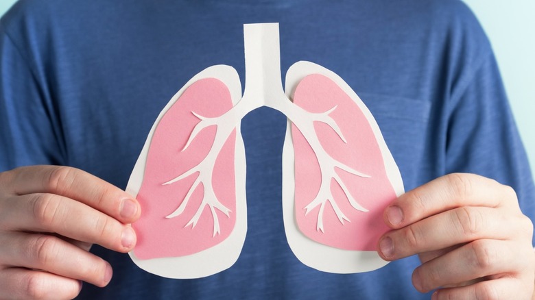 man holding picture of lungs