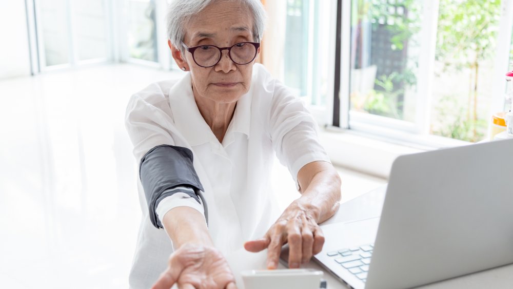 Woman monitoring blood pressure