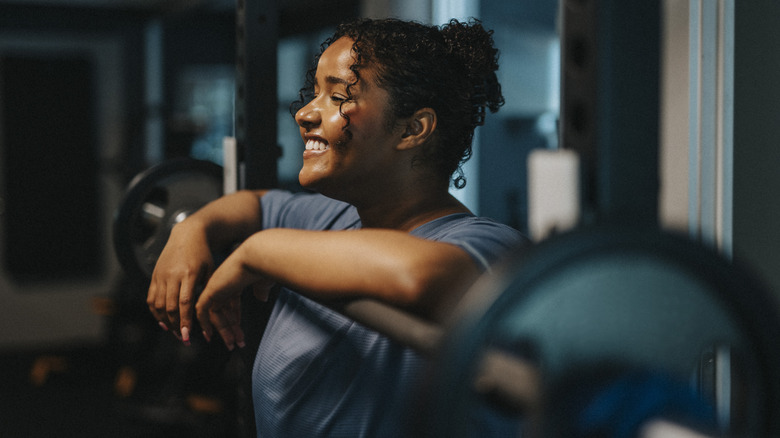 healthy young woman in a gym with weights