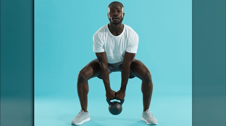 man doing weighted squat