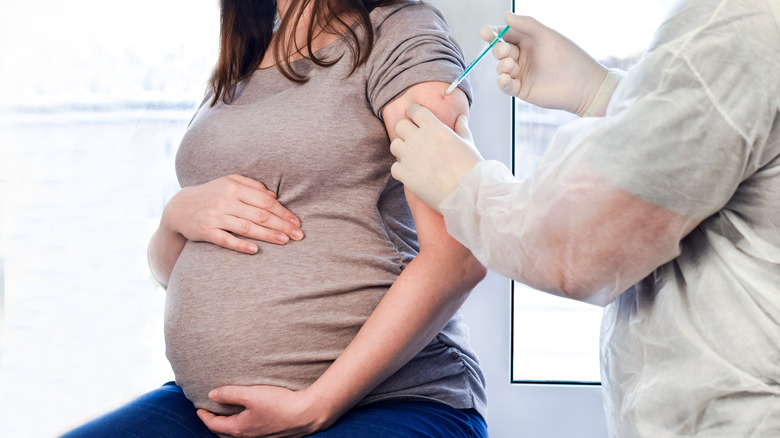 Pregnant woman receiving shot