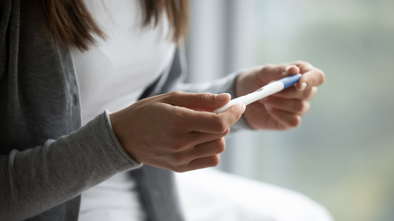 Woman looking at a pregnancy test