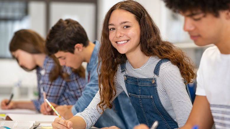 Teenagers working in school