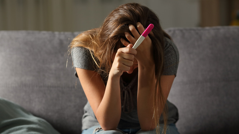 Woman stressing over pregnancy test