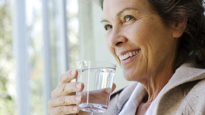 relieved woman drinking glass of water