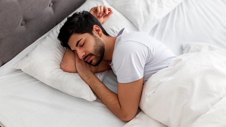 man sleeping peacefully in bed