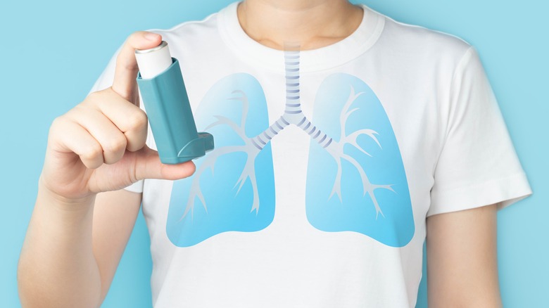 woman holding inhaler with lungs