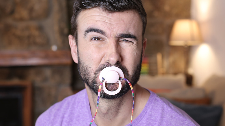 adult young man using a pacifier