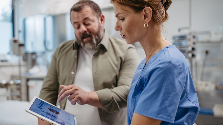 doctor consulting with overweight patient