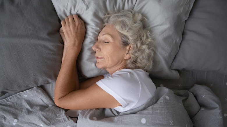 Older woman sleeping in bed