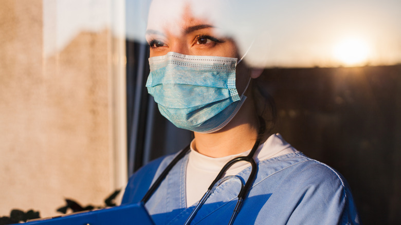 doctor looking through window