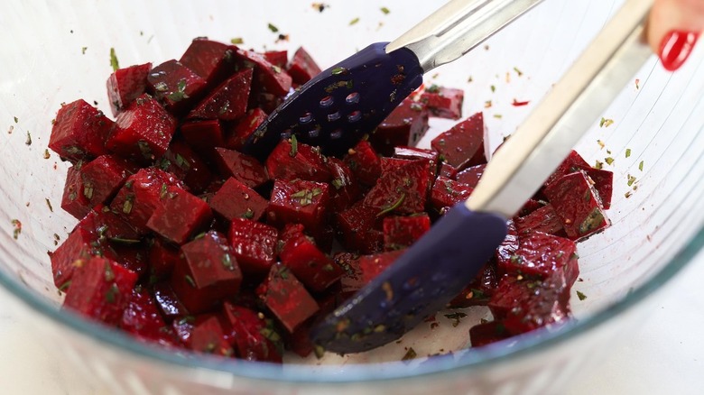 cooked beets with tongs