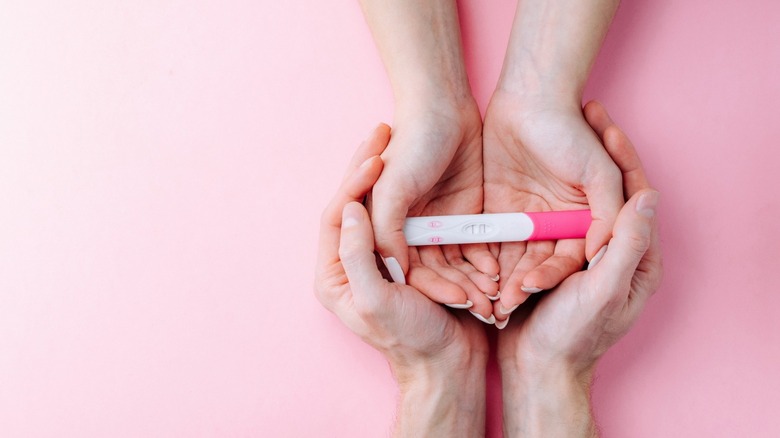 pregnancy test kit inside hands