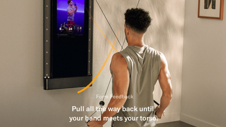 man getting form cues from Tonal machine