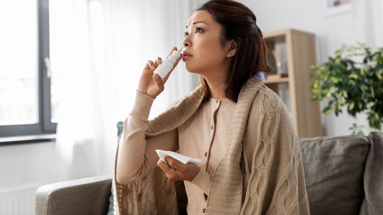 woman using nasal spray