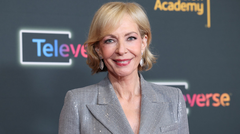 Allison Janney posing in a silver suit
