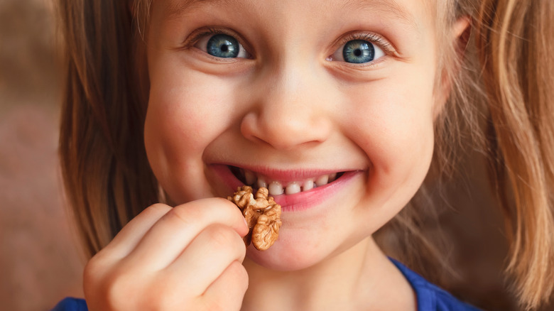 Girl eating walnut