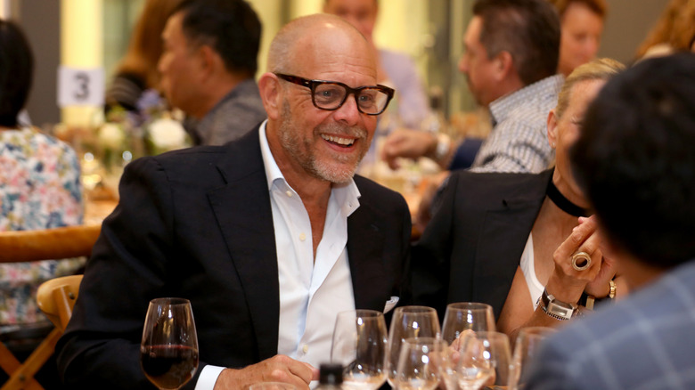 Alton Brown talking at dinner table