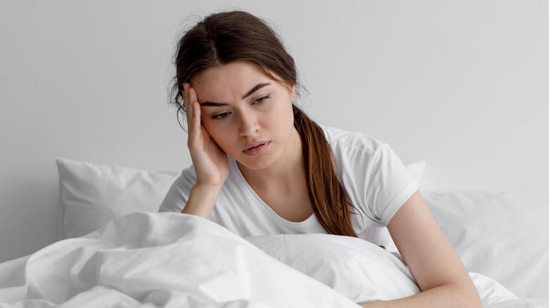 woman in bed feeling depressed