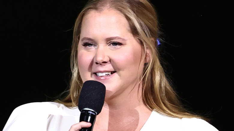 Amy Schumer speaking into microphone
