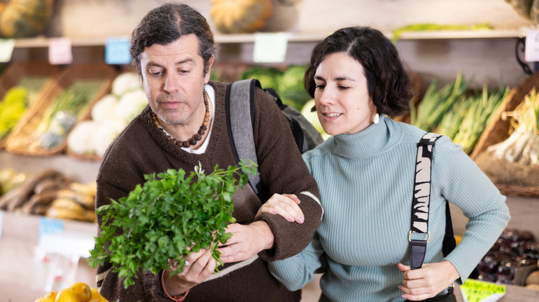 Parsley placed on a cutting board on a wooden table