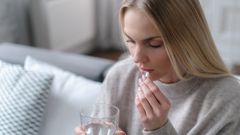A woman taking aspirin