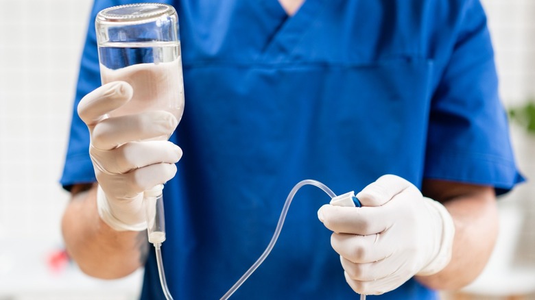 male nurse holds IV