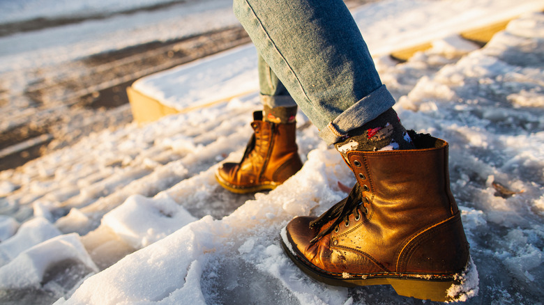 Feet walking down icy steps