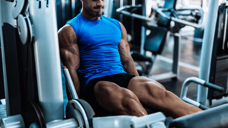 A man doing leg extensions at the gym