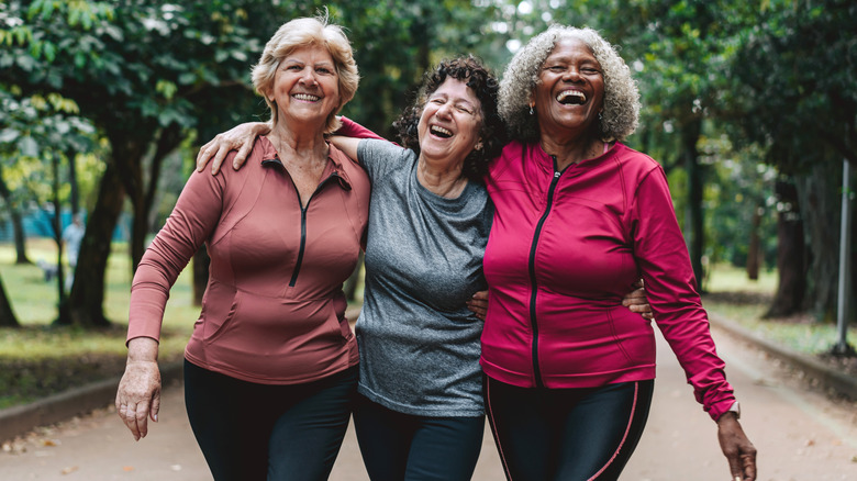 Group of senior women friends walking in the public park
