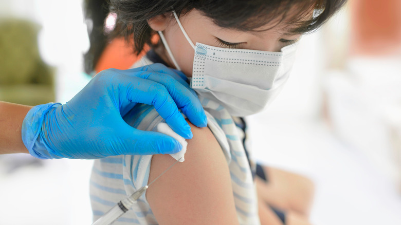 Girl getting a vaccine in her arm