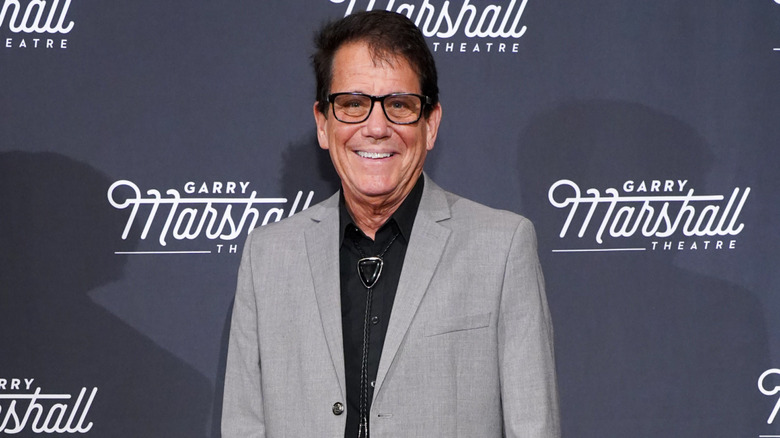 Anson Williams smiling in a gray suit jacket