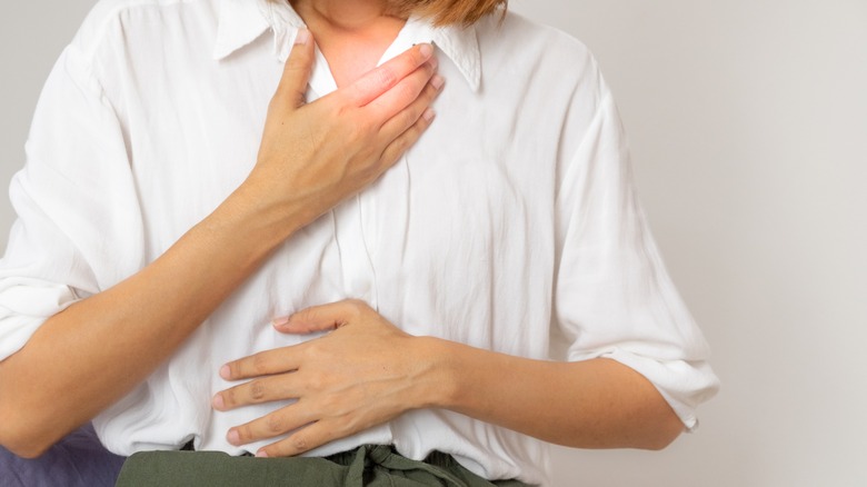 Woman with hands on chest, belly